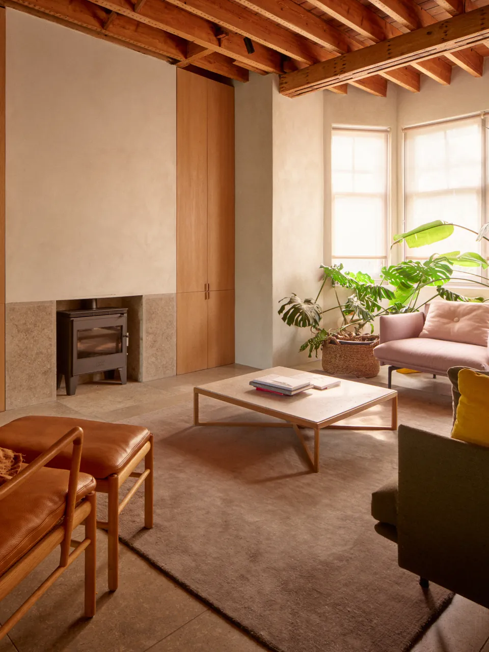 Living room with fireplace, bay window and exposed beams