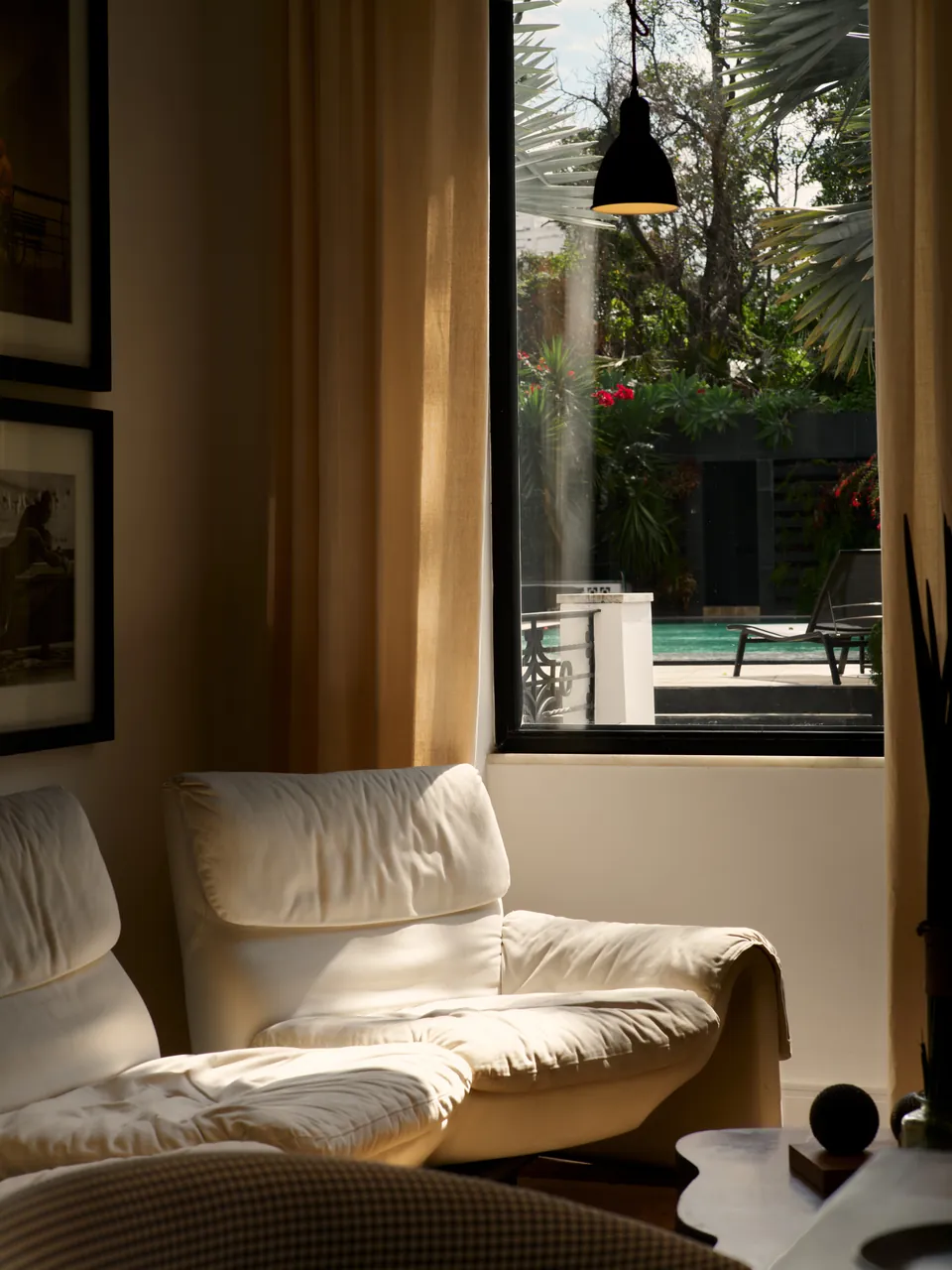 Cream leather lounge chair by an open door to the pool garden