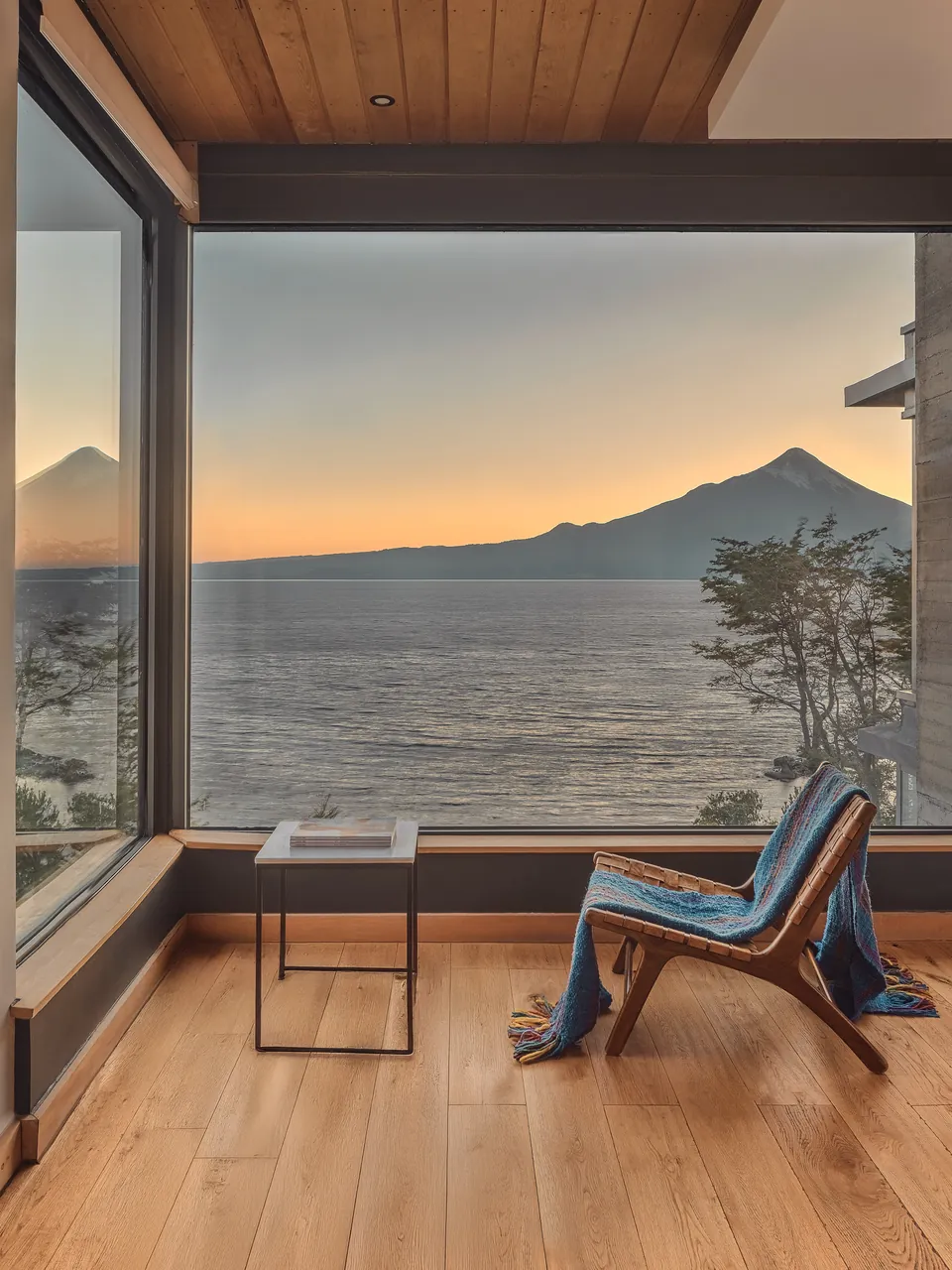 Window seat looking across the lake to a volcano at dawn