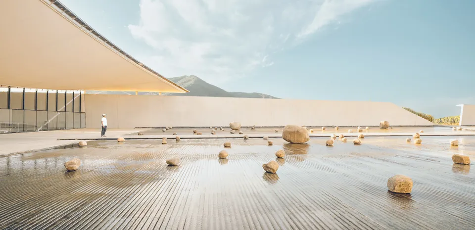 Winery roof terrace with scattered stones on a reflecting surface