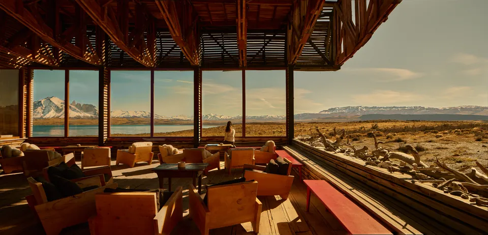 Long lounge with steppe and mountains through ribbon windows
