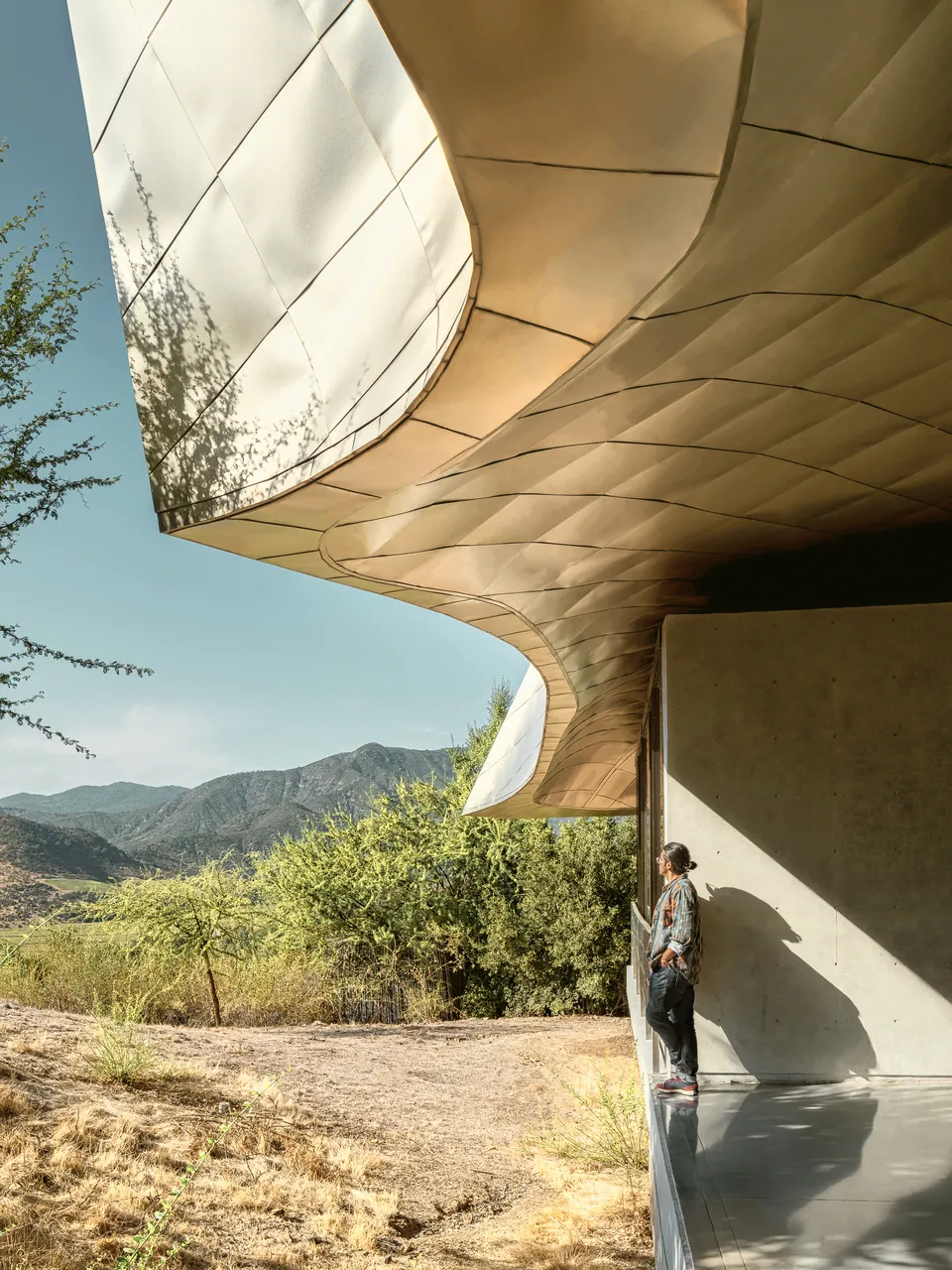 Curved metallic roof edge with the valley beyond
