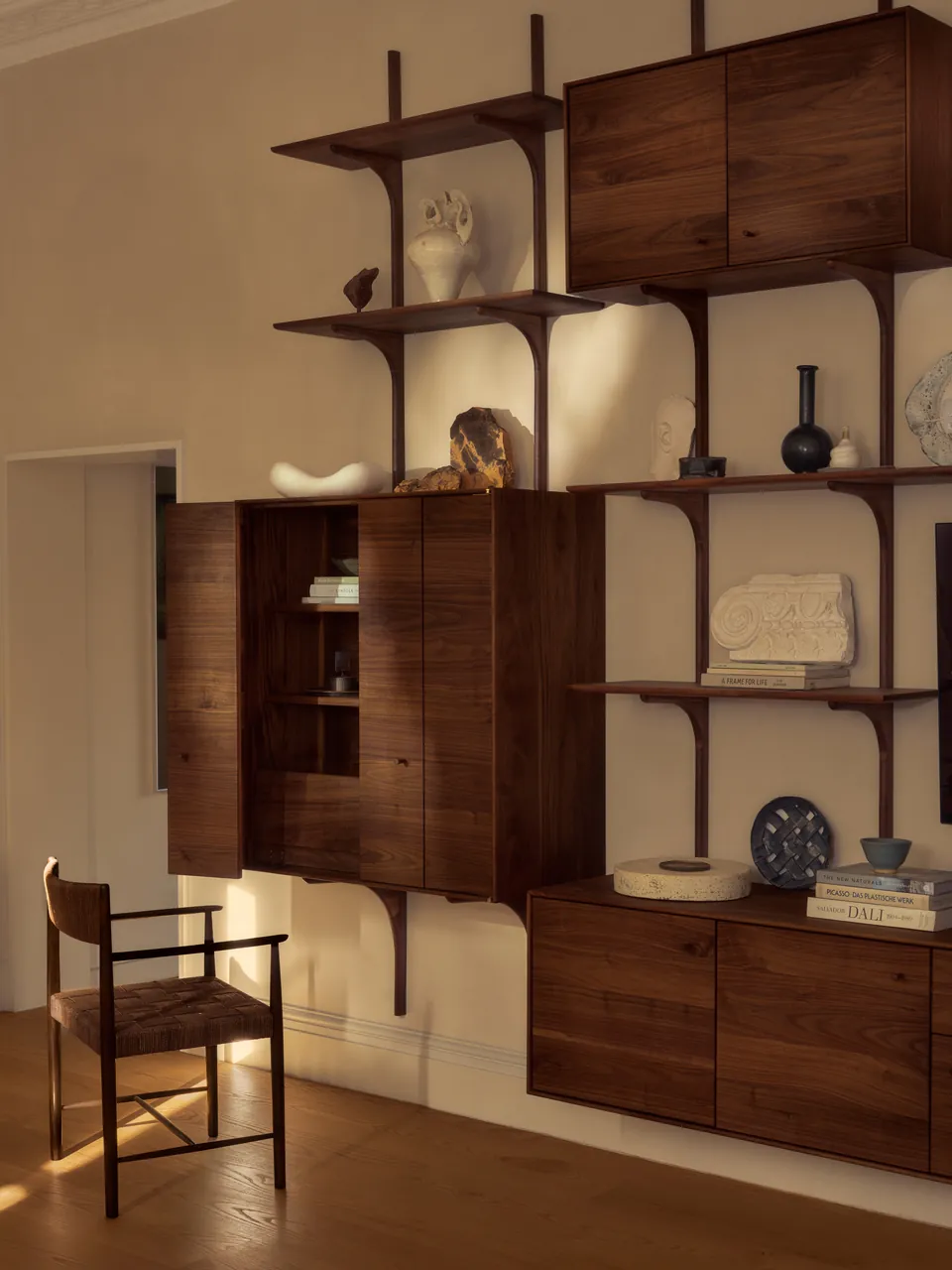 Walnut shelving with an open cabinet and a chair