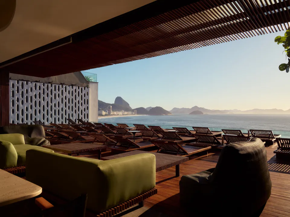 A rooftop terrace with loungers looking out to Sugarloaf Mountain