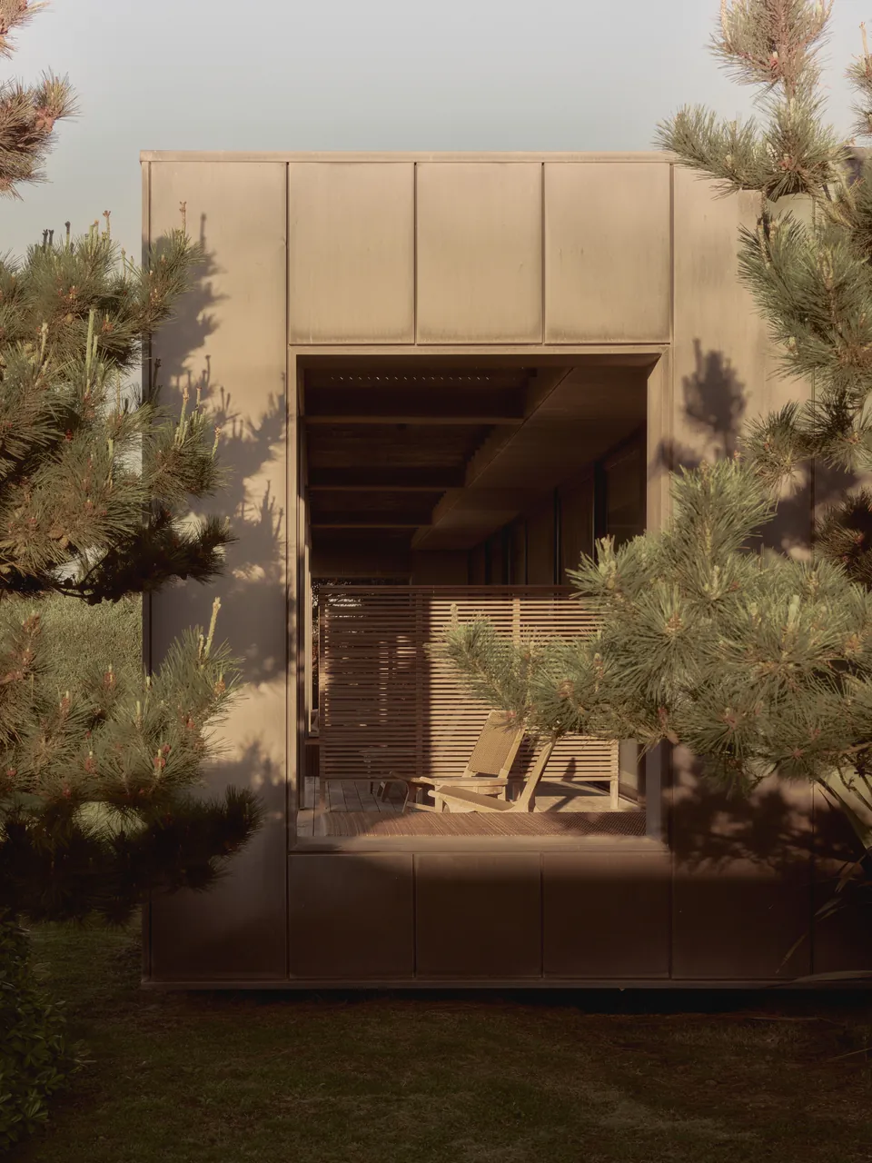 A pavilion among pines, its doors open
